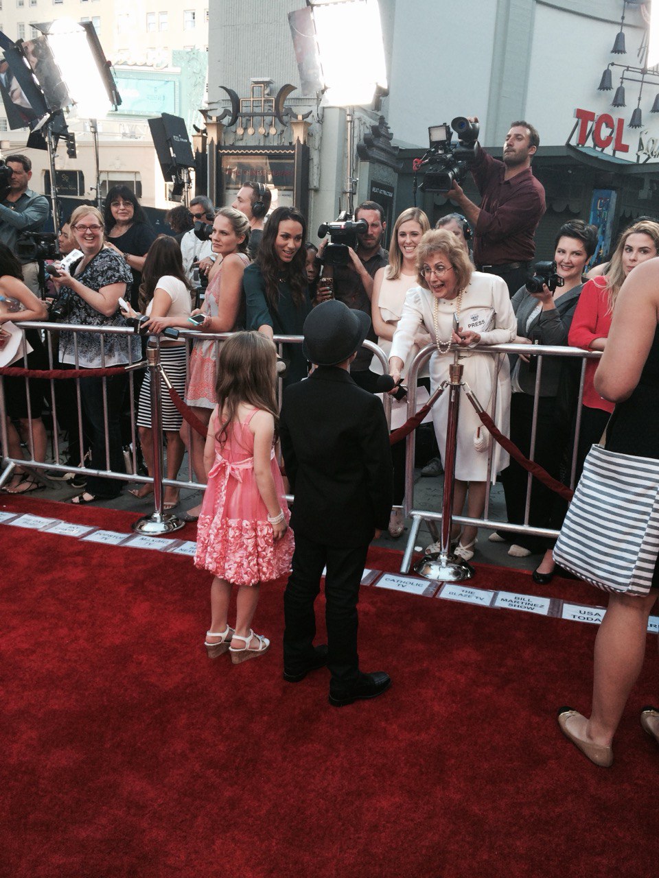 Young talent on the red carpet at a Hollywood premiere